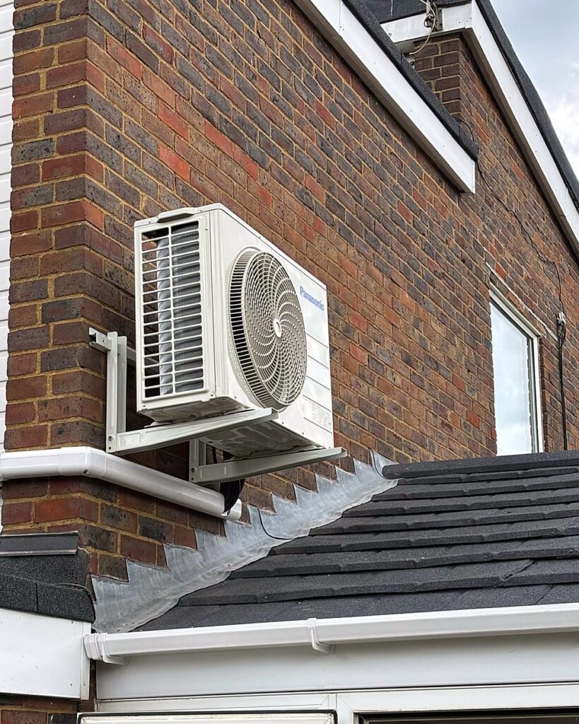 Panasonic air conditioning outdoor unit on a wall bracket above a conservatory roof, installed by A.C. Wilgar