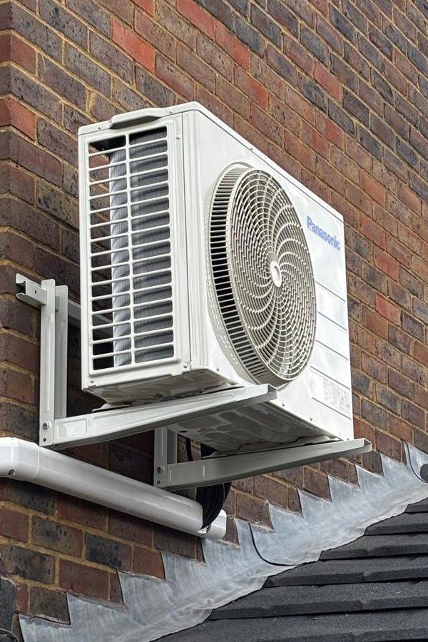 Panasonic air conditioning outdoor unit on a wall bracket above a conservatory roof, installed by A.C. Wilgar